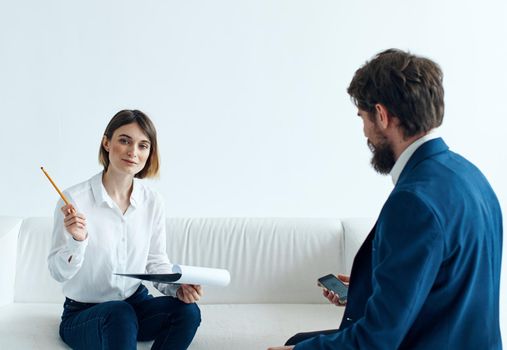 Woman on sofa indoors psychologist communicating and man in suit. High quality photo