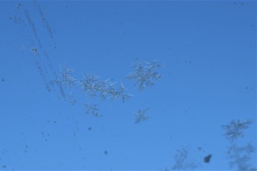 Texture as a frosty pattern on a window glass as a close-up
