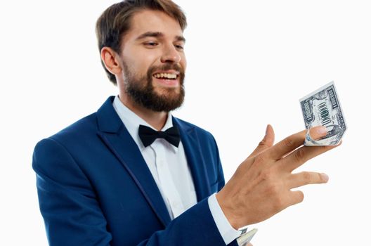 happy man with bundle of money and in classic suit on white background cropped view. High quality photo