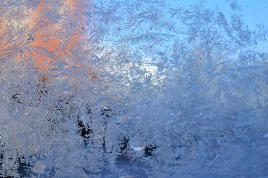 Texture as a frosty pattern on a window glass as a close-up