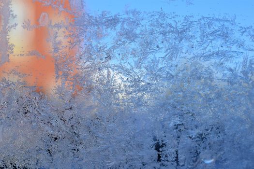 Texture as a frosty pattern on a window glass as a close-up