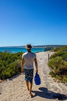 young caucasian man walking down a pathway to Hamelin Beach. This Beach is famous for his stingrays, Hamelin Beach