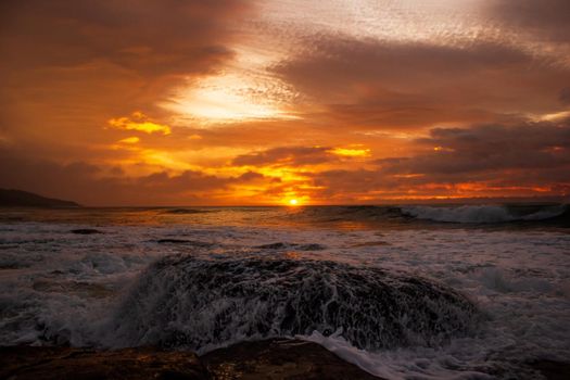 waves crushing a rock during sunrise. Sea sunrise at the great Ocean Road, Victoria