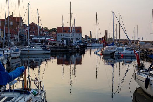 Bornholm, Denmark - August 6, 2020: Sailboats anchored at the small harbor in Allinge