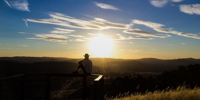 Young man is looking at the sunset, Albury, New South Wales, Australia