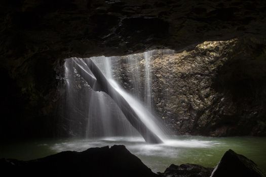 The Natural Bridge waterfall at Springbrook National Park. Its also known as a glow worm cave, Queensland Australia.