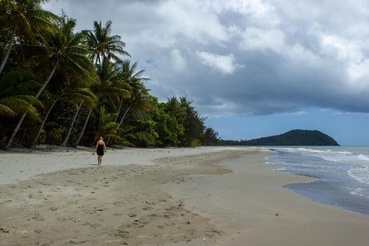 young women walking on the beach in Cape Tribulation in Daintree National Park in the far tropical north of Queensland