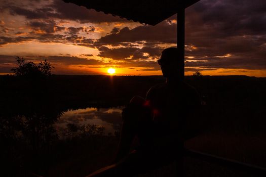 jung man enjoying beautiful sunset in the australian outback with 3 lakes, Nitmiluk National Park