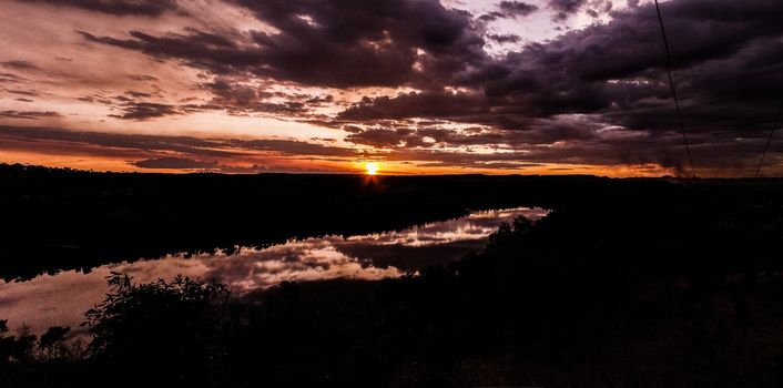 shot through tress of a beautiful sunset in the australian outback with 1 lakes, Nitmiluk National Park