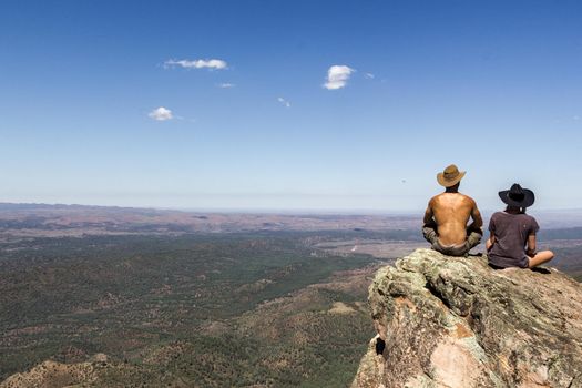 jung women and men sitting on St Mary's Peak from the Flinders Ranges National Park, Australia