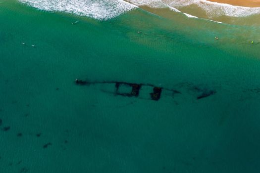 Aerial view of a shipwreck at Wategos Beach in Byron Bay. The photo was taken from a gyrocopter in Byron Bay, Queensland.