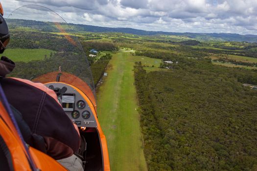 Gyrocopter is landing on an airfield out of gras, Byron Bay, Queensland, Australia.