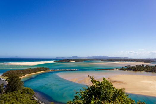 Flat sand dunes on the delta of the Nambucca River, which enters the Pacific Ocean through wide sandy beaches of the Australian coast around Nambucca Heads Town.