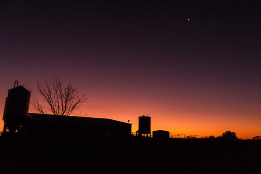 silhouette of a dairy farm building at sunset on a dairy farm, victoria