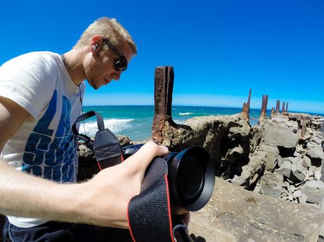 yung man sitting on the old Sea Cliff Bridge along the Grand Pacific Drive, Australia, New South Wales