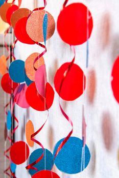 The decor is made of colored paper circles. Color decorative curtain. Decor for the holiday. Festive mood.