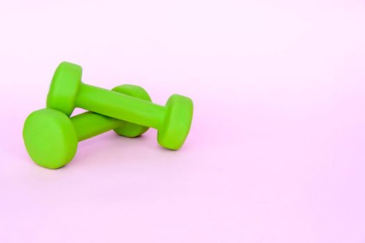 A green apple, and a centimeter measuring tape on a pink background. Sports, sports nutrition, healthy eating, diet. Space for the text. Exercise, lose weight 