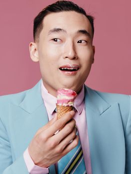 A Korean man in a suit with ice cream in his hand looks away in surprise. High quality photo