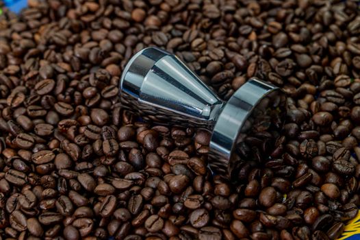 coffee beans with steel coffee press for bars