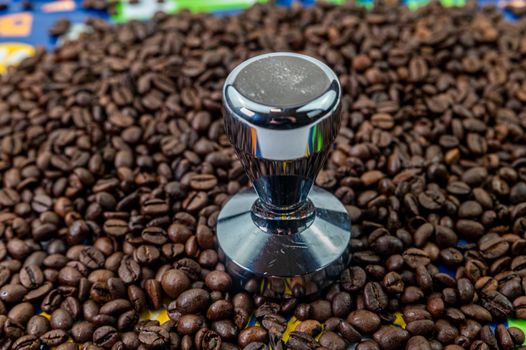 coffee beans with steel coffee press for bars