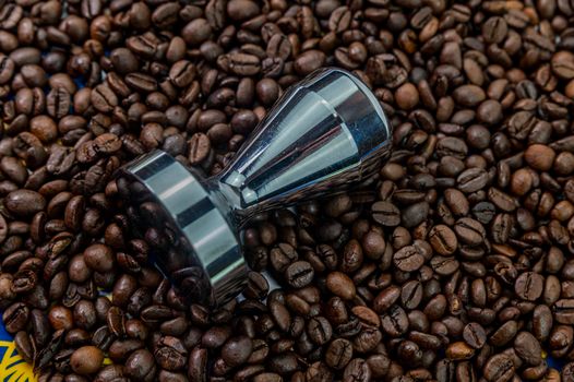 coffee beans with steel coffee press for bars