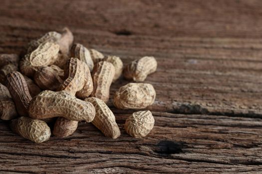 Peanuts on a wooden background. Top view.