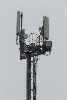 communication and gsm, wcdma, hspda and other 3g, 4g standarts tower close-up in cloudy weather.