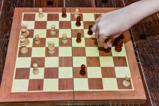 White and black chess pieces stand on board during a chess game. top view.