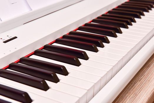 Close-up of a electronic piano keyboard. white digital piano for playing classical or modern music.