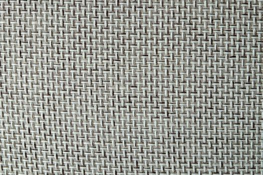 Close-up of a textured fabric. Macro shot of gray upholstery for furniture. Wallpaper and background. Closeup grey fabric texture. Thick gray material for the interior.