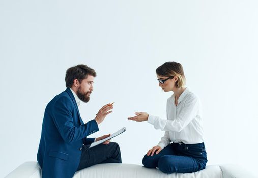 Business men and women sit on the couch communicating employees . High quality photo