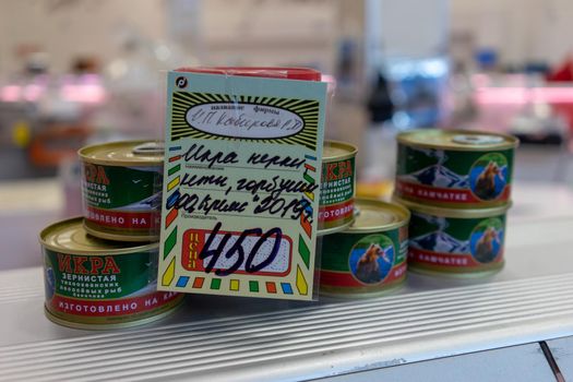 Petropavlovsk-Kamchatsky, Russia-October 6, 2019: red caviar in jars at the seafood market showcase.