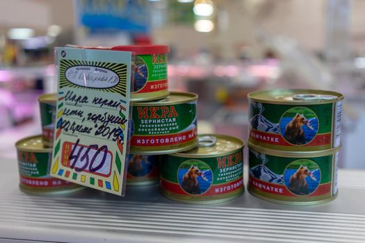Petropavlovsk-Kamchatsky, Russia-October 6, 2019: red caviar in jars at the seafood market showcase.