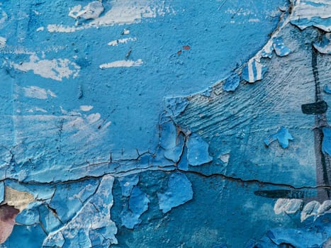 Blue background with cracked oil paint on plaster. For design and networking.