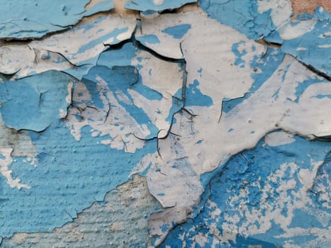Blue background with cracked oil paint on plaster. For design and networking.
