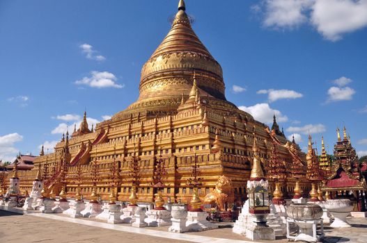 BAGAN, MYANMAR - NOVEMBER 18, 2015: Sacred Shwezigon pagoda. Golden paya, buddhist temple in old ancient capital in Burma. Famous tourist destination. Mingalazedi Sulamani Shwezigon Ananda Htilominlo