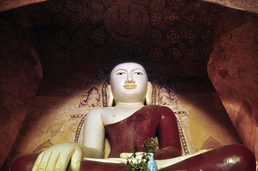 BAGAN, MYANMAR - NOVEMBER 18, 2015: Huge colored statue of Buddha in temple, From below shot of colorful Buddha statue in ornamental temple. Mingalazedi Sulamani Shwezigon Ananda Htilominlo