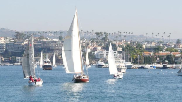 NEWPORT BEACH, CALIFORNIA, USA - 03 NOV 2019: Marina resort with yachts and sailboats, Pacific coast near Los Angeles. Regatta of nautical vessels, sail boat in harbor. Luxury suburb in Orange County.