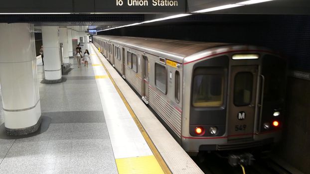 LOS ANGELES, CALIFORNIA, USA - 7 NOV 2019: Metro Rail transportation system. Metropolitan public passenger railway transport infrastructure. Citizens inside underground subway. People in LA City.