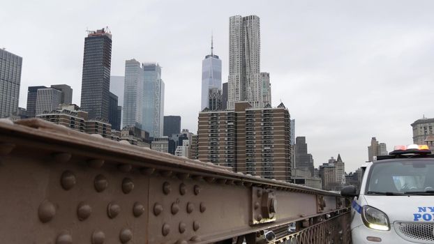 NEW YORK CITY, USA - 12 MAR 2020: Emergency siren glowing, 991 police patrol car on Brooklyn bridge. NYPD auto, symbol of crime prevention and safety in Manhattan. Metropolis security and protection.