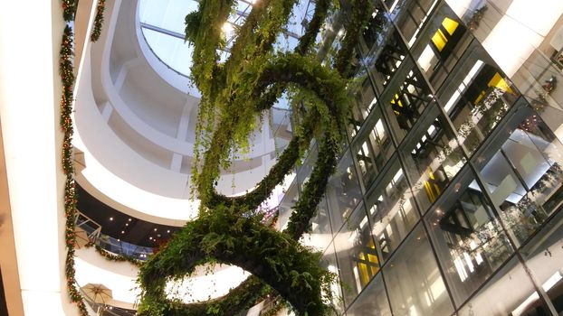 BANGKOK, THAILAND - 18 DECEMBER, 2018 The Emquartier luxury shopping center. Design of mall, green environmentally friendly concept. hanging garden, futuristic eco architecture. Modern city. Escalator