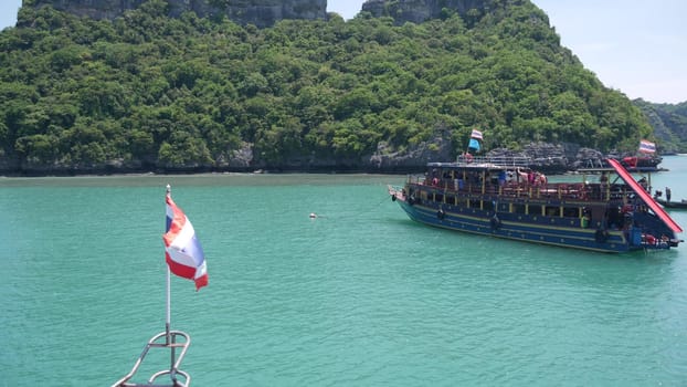 ANG THONG MARINE PARK, SAMUI, THAILAND - 9 JUNE 2019: Group of Islands in ocean near touristic paradise tropical resort. Idyllic turquoise sea with boat with tourists. Travel vacation holiday concept.