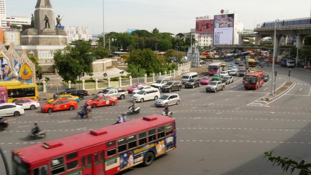 BANGKOK, THAILAND - 10 JULY, 2019: Rush hour traffic near Victory Monumet in Krungthep capital. Famous asian landmark and travel destination. Downtown modern city life. People and passengers of bts