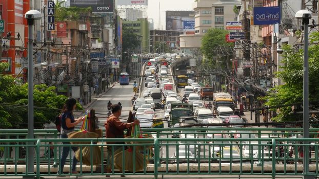 BANGKOK, THAILAND - 10 JULY, 2019: Rush hour traffic near Victory Monumet in Krungthep capital. Famous asian landmark and travel destination. Downtown modern city life. People and passengers of bts