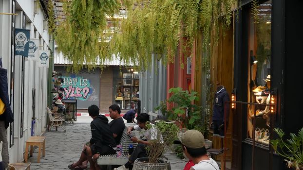 BANGKOK, THAILAND - 10 JULY, 2019: People walking at the Camp vintage flea market near Chatuchak. Design of retro style boutique art shops of antiques. Decoration of popular fashion city landmark