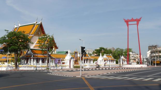 BANGKOK, THAILAND - 11 JULY, 2019: Giant Swing religios historic monument near traditional wat Suthat buddist temple. Iconic city view, cultural symbol. Famous landmark and classic tourist attraction