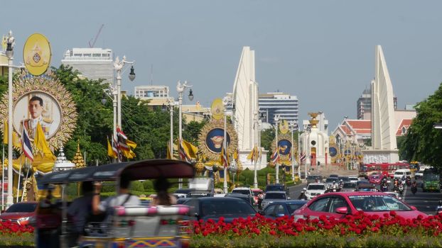 BANGKOK, THAILAND - 11 JULY, 2019: Rush hour traffic near Democracy Monument in capital. Famous asian landmark and travel destination. Democratic and patriotic symbol and public transport in downtown.