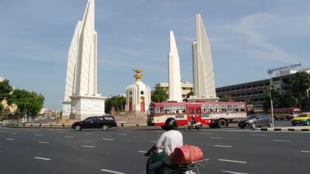 BANGKOK, THAILAND - 11 JULY, 2019: Rush hour traffic near Democracy Monument in capital. Famous asian landmark and travel destination. Democratic and patriotic symbol and public transport in downtown.