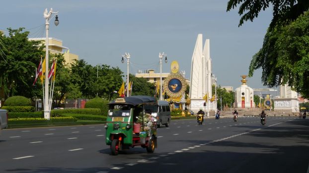 BANGKOK, THAILAND - 11 JULY, 2019: Rush hour traffic near Democracy Monument in capital. Famous asian landmark and travel destination. Democratic and patriotic symbol and public transport in downtown.