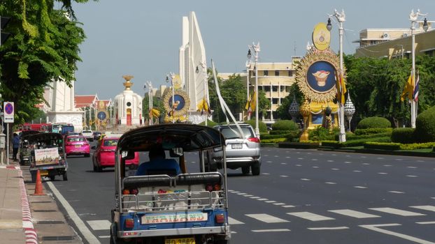 BANGKOK, THAILAND - 11 JULY, 2019: Rush hour traffic near Democracy Monument in capital. Famous asian landmark and travel destination. Democratic and patriotic symbol and public transport in downtown.